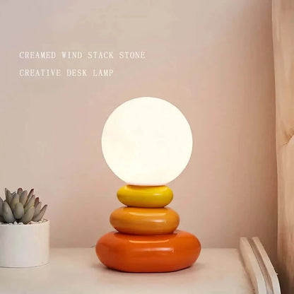 The Pebble Stack 70s revival table lamp in orange or blue